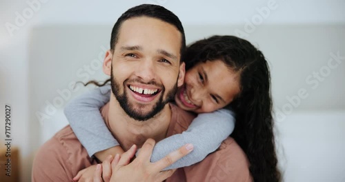 Family, love and surprise with daughter hugging father in bedroom of home together for playful bonding. Portrait, smile or playing with happy man parent and girl child laughing on bed in apartment photo