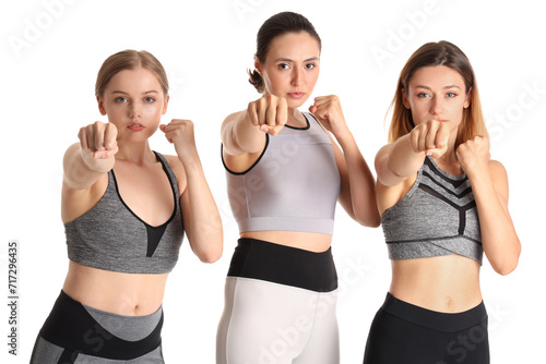 Young women training on white background. Concept of self defense photo