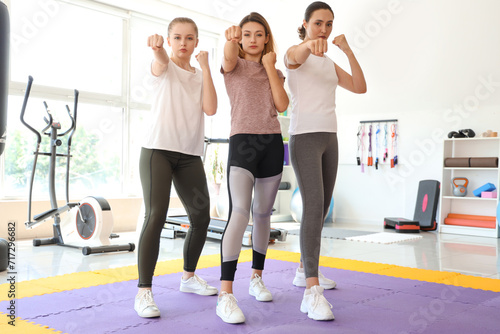 Young women training at self defense courses in gym