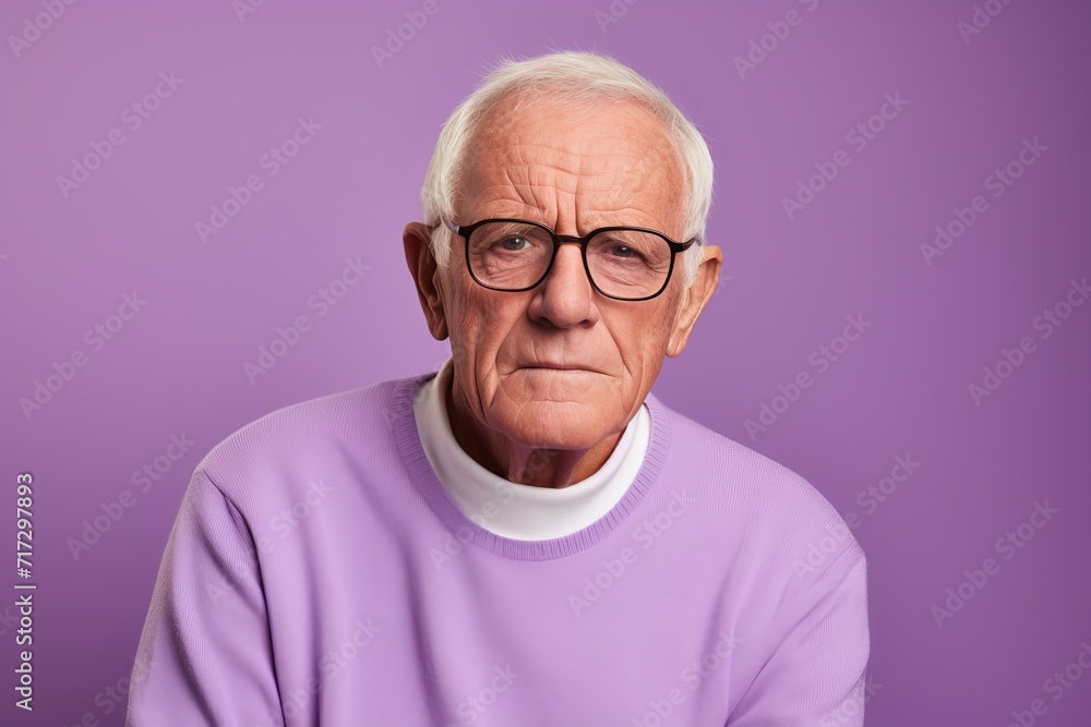Portrait of an old man with glasses on a purple background. Portrait of an old man with glasses on a purple background.