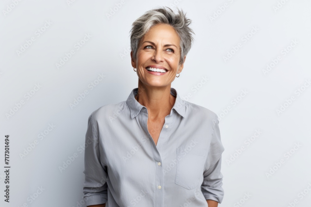 Portrait of happy senior businesswoman with grey hair smiling at camera Portrait of happy senior businesswoman with grey hair smiling at camera