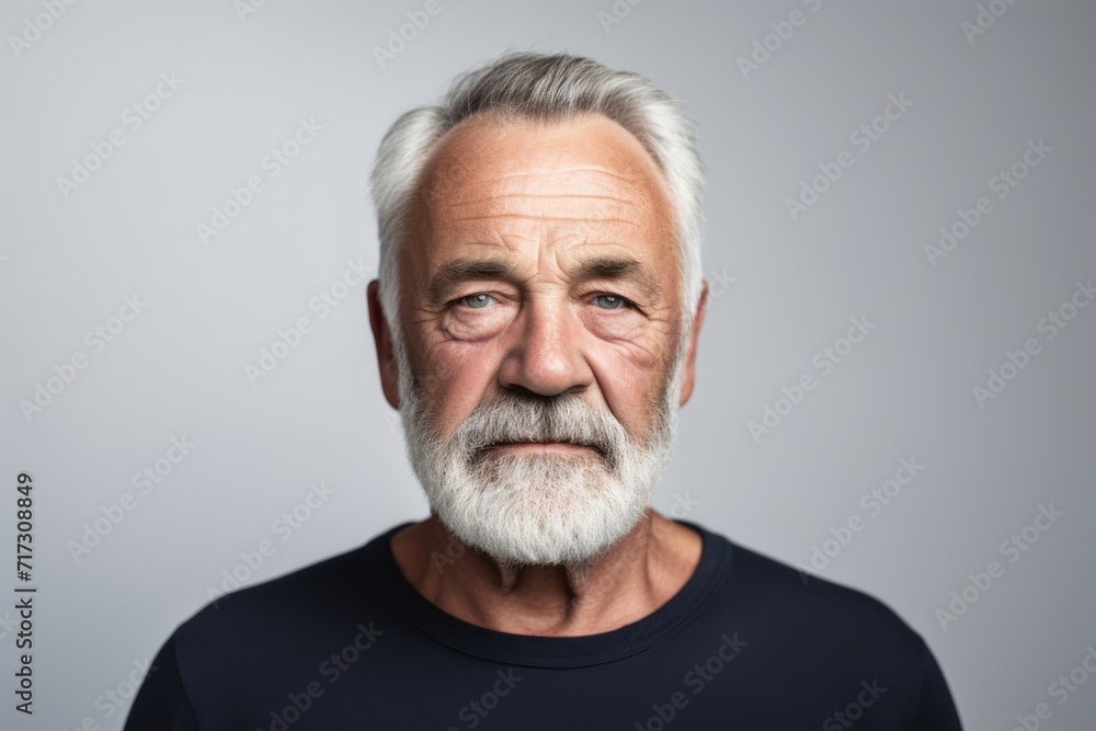 Portrait of a senior man with grey hair and beard. Studio shot. Portrait of a senior man with grey hair and beard. Studio shot.