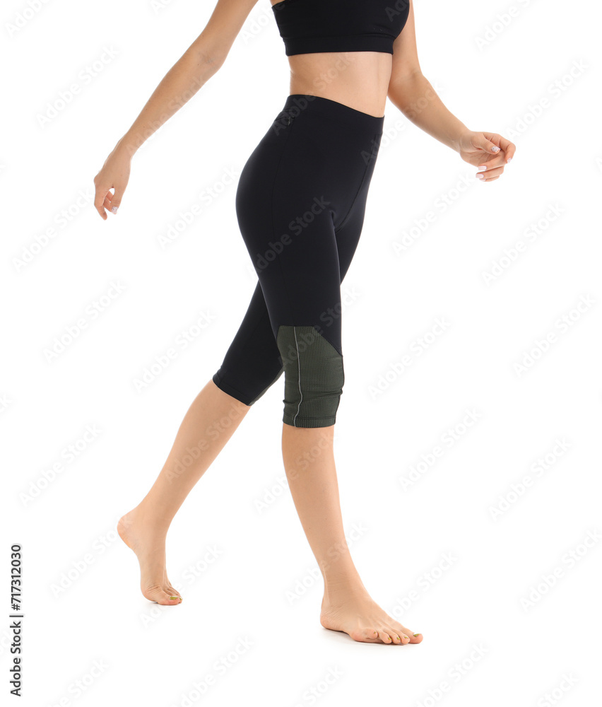 Young woman in black cycling shorts on white background