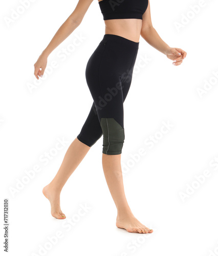 Young woman in black cycling shorts on white background