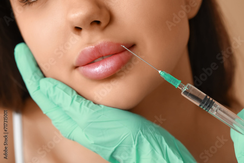 Young woman receiving lip injection  closeup