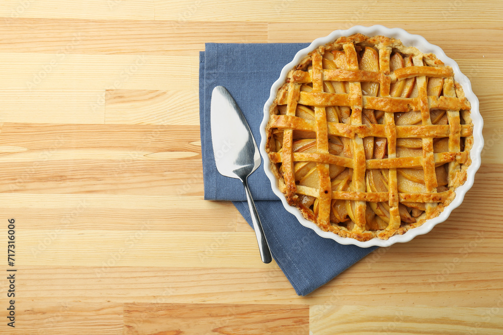 Tasty homemade quince pie and cake server on wooden table, top view. Space for text Tasty homemade quince pie and cake server on wooden table, top view. Space for text
