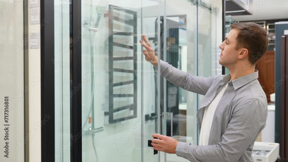 A man choosing shower for his home bathroom. A man choosing shower for his home bathroom.