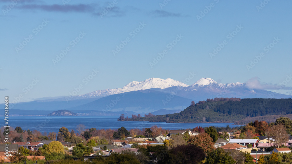 Snow capped mountains over lake Taupo and town, New Zealand