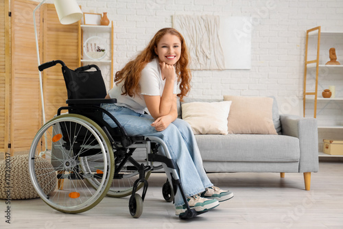 Young redhead woman in wheelchair at home © Pixel-Shot