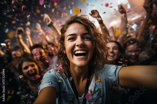 At a lively music festival, a girl captures the infectious joy of the crowd, the vibrant lights, and the excitement of the event in her dynamic selfie.