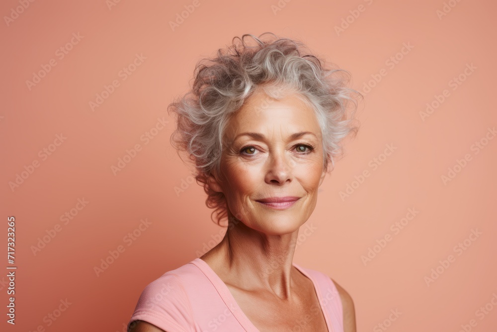 Portrait of a beautiful senior woman with gray hair on a pink background Portrait of a beautiful senior woman with gray hair on a pink background