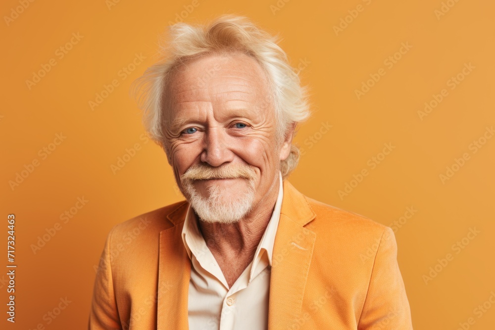 Portrait of smiling senior man in orange jacket on orange background. Portrait of smiling senior man in orange jacket on orange background.