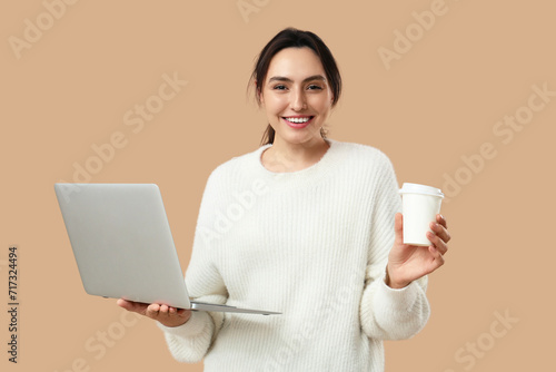 Smiling young woman holding...
