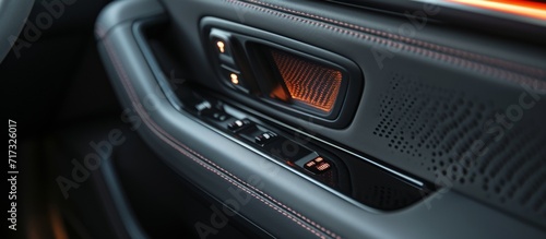 Modern car door has a button for seat heater.