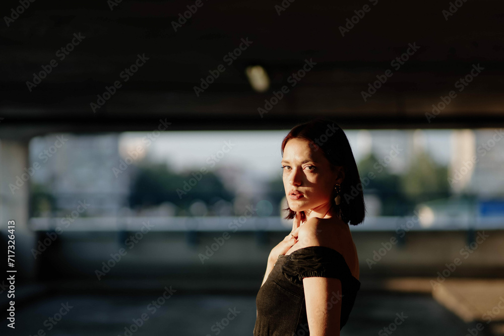 sensual beautiful brunette woman in black dress enjoying the sun, beautiful model