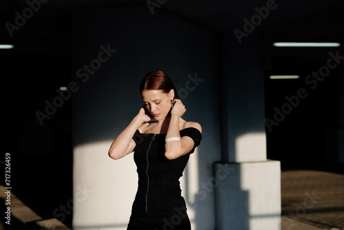 sensual beautiful brunette woman in black dress enjoying the sun, beautiful model