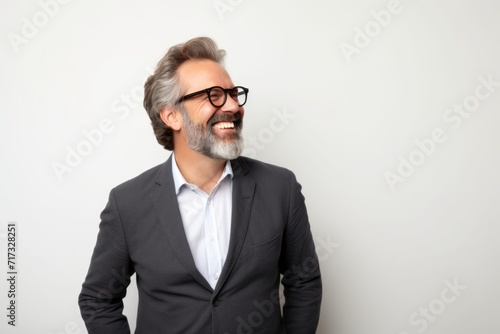 Portrait of a handsome senior man with gray hair and beard wearing glasses © Iigo