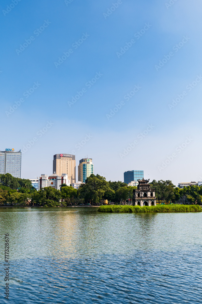 Fototapeta premium Hoan Kiem lake in Hanoi, Vietnam, with famous Turtle tower. An iconic lake, downtown Hanoi, Vietnam