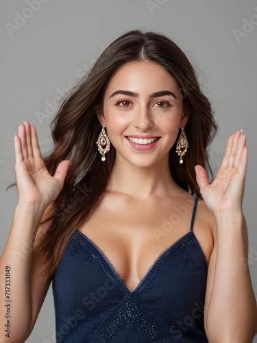 attractive young beautiful girl expressing surprise with both hands raised