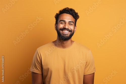 happy african american man in yellow t-shirt on yellow background