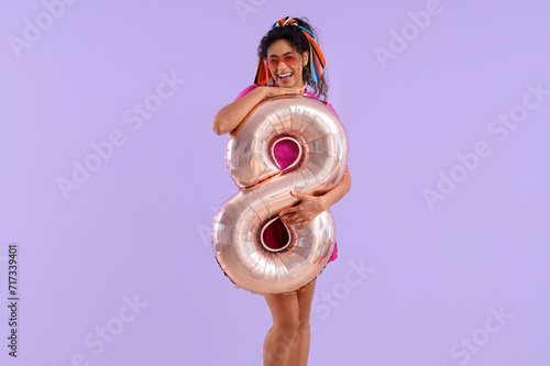Happy young woman holding a...