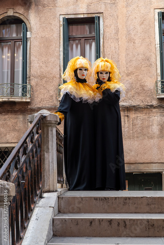 Two womans wearing venetian carnival masks. Elegance, mystery and style at the famous Venice carnival.