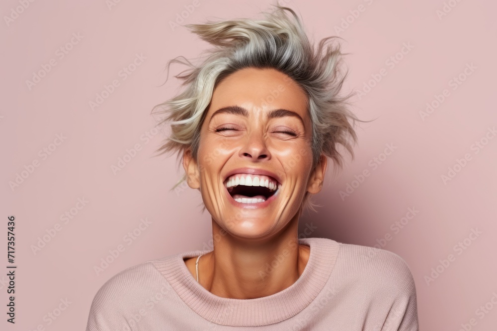 Portrait of a happy young woman laughing and looking at camera. Portrait of a happy young woman laughing and looking at camera.