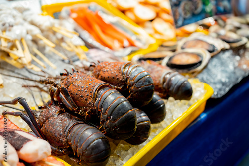 Fresh seafood selling at Kuromon Ichiba in Osaka Japan. The Kuromon Ichiba is a spacious market with vendors selling street food, fresh produce and shellfish, plus souvenirs, Seafood in Kuromon Market