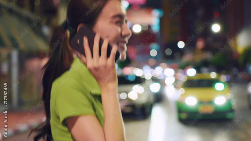 Asian attractive woman backpacker talking on phone while walk in city. Asian attractive woman backpacker talking on phone while walk in city.