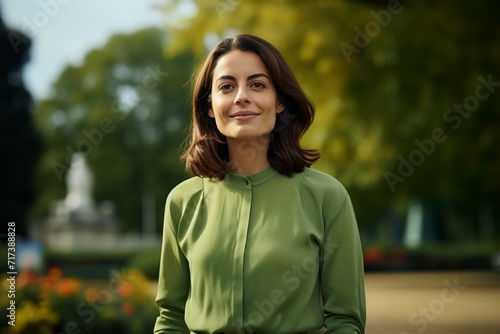 Portrait of a beautiful brunette woman in a green blouse