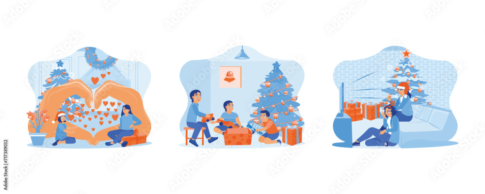 Family sharing Christmas Eve. Three little children opening Christmas presents together under the Christmas tree. Two female friends sitting together near the Christmas tree. 