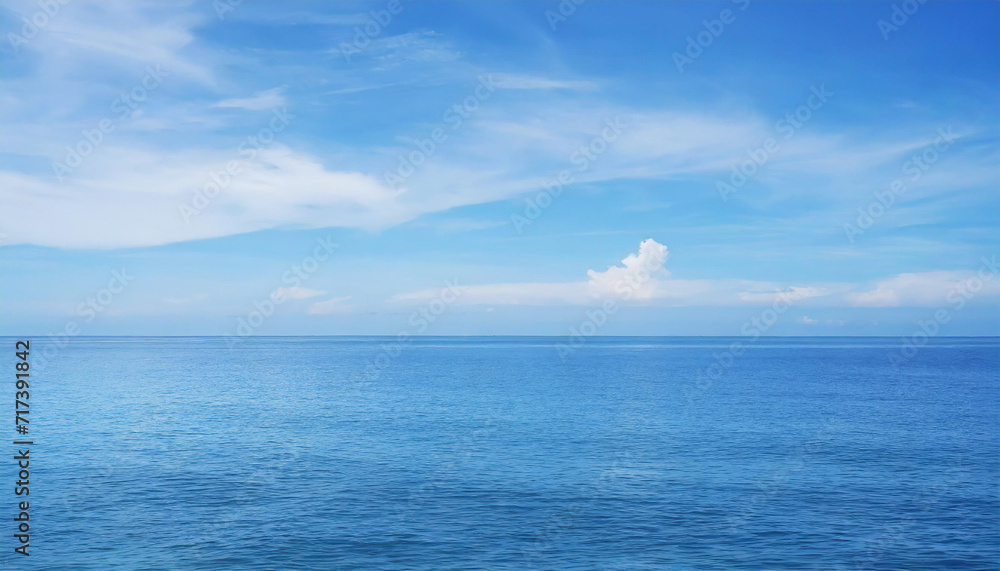 Tranquil Seascape under a Clear Blue Sky with Fluffy Clouds on a Sunny Summer Day