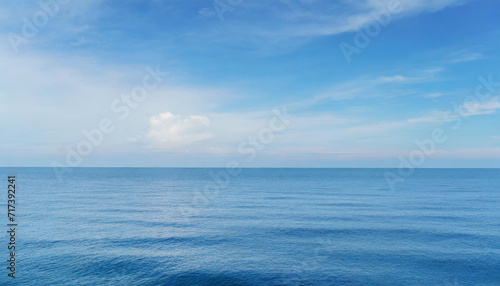 Tranquil Seascape under a Clear Blue Sky with Fluffy Clouds on a Sunny Summer Day