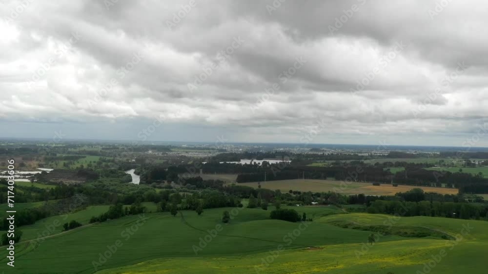 Time Lapse Aerial view green agricultural field cloudy spring day drone flying Time Lapse Aerial view green agricultural field cloudy spring day drone flying