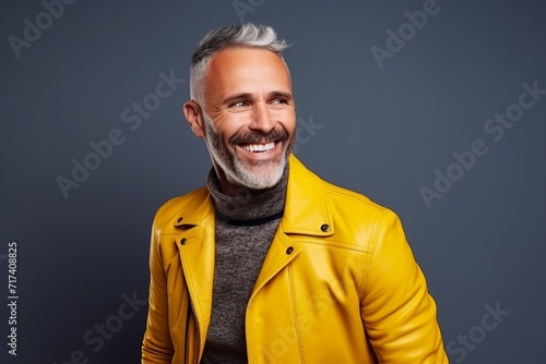 Portrait of a handsome mature man in a yellow leather jacket.