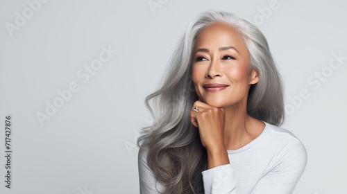 Smiling happy older lady advertising anti age face skin and body care cosmetics