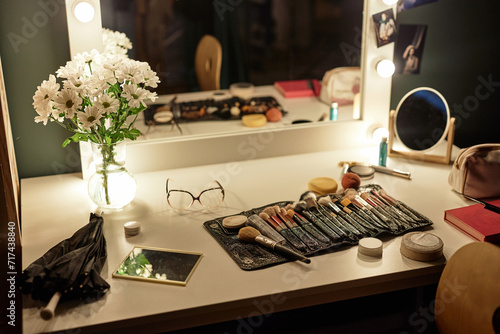 Background image of makeup brushes over vanity table with lights at backstage in theater, copy space