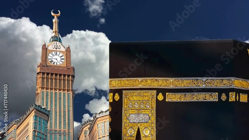 Timelapse of Holy mosque of Mecca and Makkah Clock Royal Tower. Haram Mosque minaret in a cloudy day. Mecca, Islam’s holiest city and the central Masjid al-Haram, Sacred Mosque surrounds the Kaaba.  photo