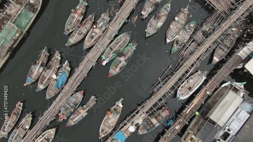 Aerial footage of boats docked at the pier in a slum and densely populated area in Cilingcing, Tanjung Priok, North Jakarta | Perahu kayu bersandar di Dermaga Wilayah kumuh padat penduduk 4K Drone photo