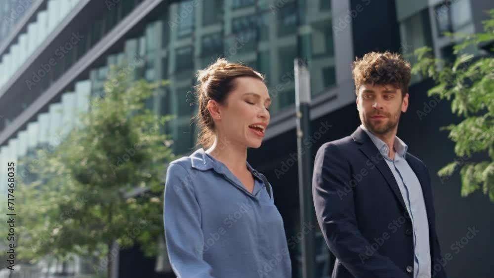 Business managers going outside together closeup. Smiling partners communicating Business managers going outside together closeup. Smiling partners communicating