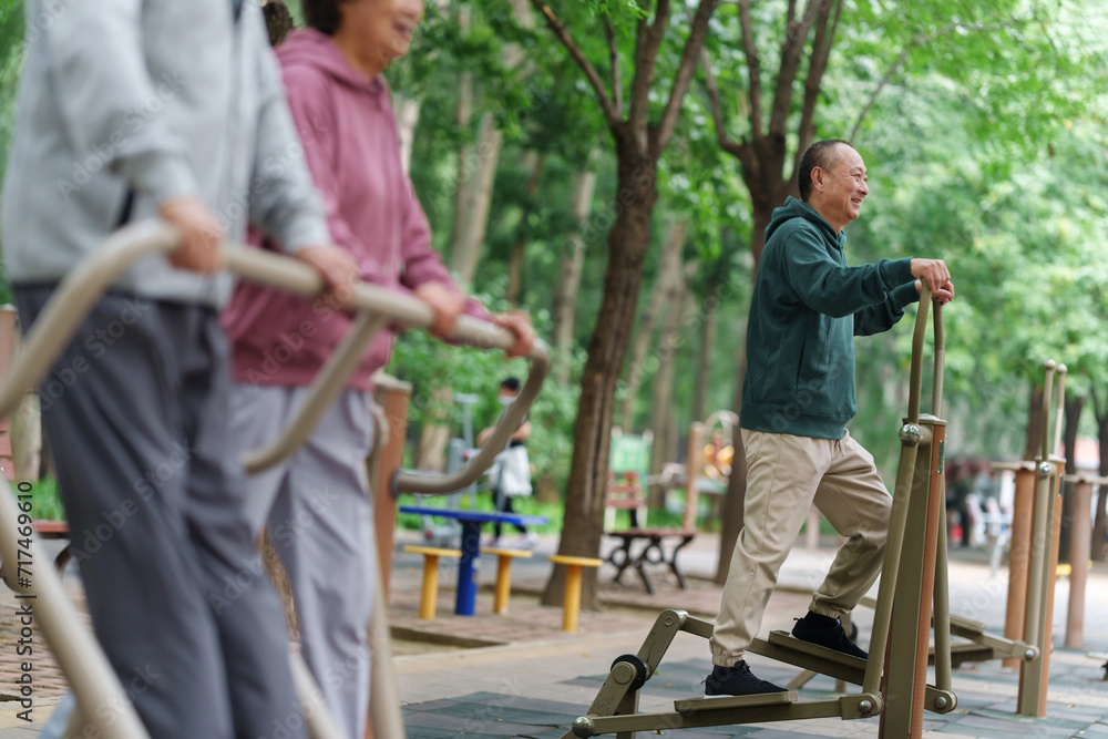 Old people who exercise with exercise equipment in the park Old people who exercise with exercise equipment in the park
