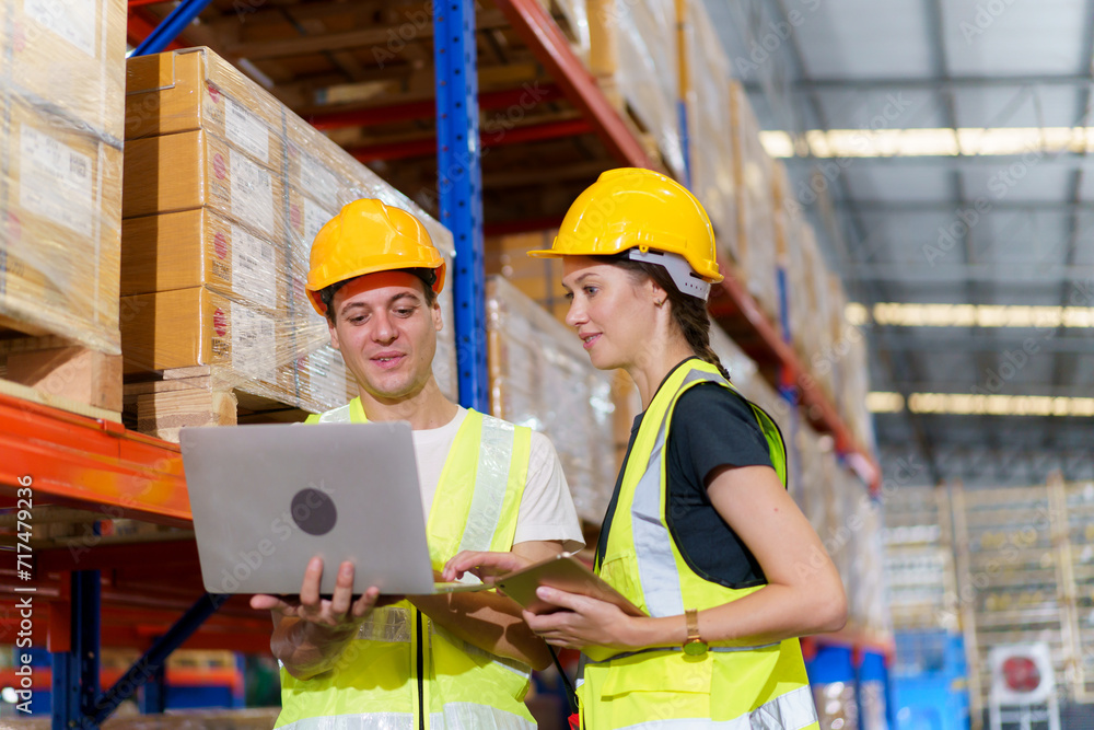 The male and female warehouse officers are currently working together to conduct a thorough stock inventory within the warehouse The male and female warehouse officers are currently working together to conduct a thorough stock inventory within the warehouse