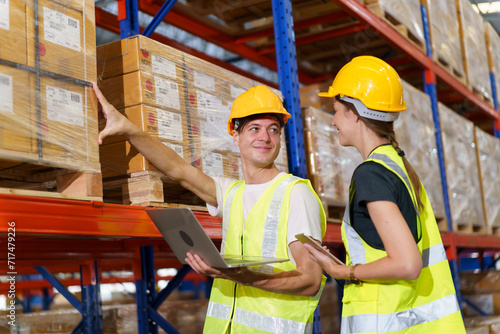 The male and female warehouse officers are currently working together to conduct a thorough stock inventory within the warehouse