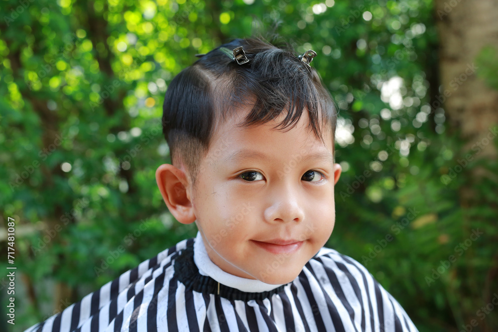 Asian boy cut in haircut in the garden, fashion haircut for a guy. Asian boy cut in haircut in the garden, fashion haircut for a guy.