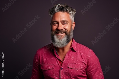 Portrait of a handsome mature man with gray hair and beard.