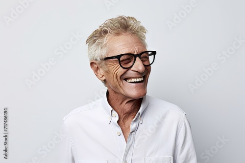 Portrait of happy senior woman with eyeglasses smiling at camera photo