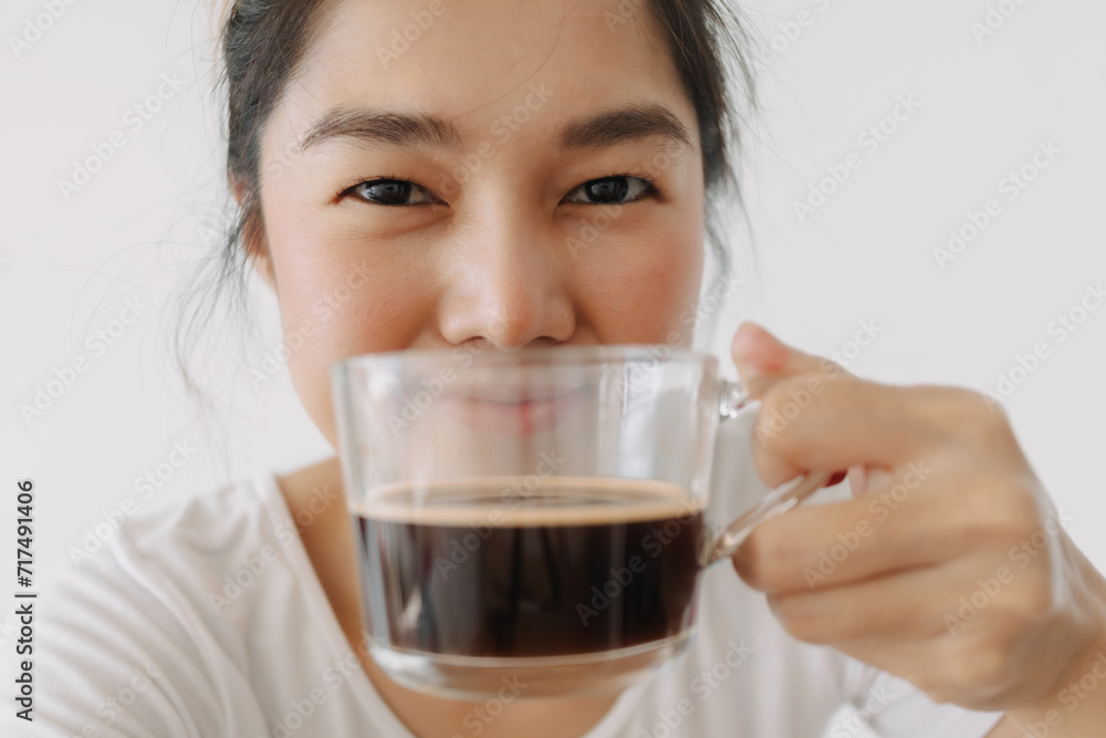Close up of woman holding and showing hot coffee mug in front, happy smiling drink tea cup in the morning, isolated over white background wall. Close up of woman holding and showing hot coffee mug in front, happy smiling drink tea cup in the morning, isolated over white background wall.