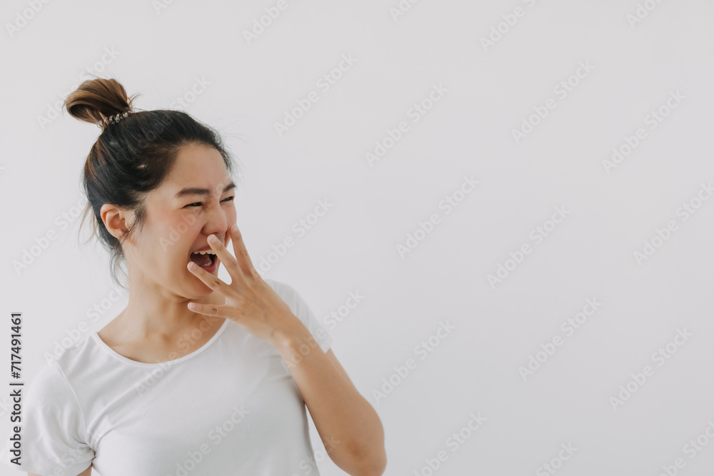 Happy asian Thai woman hand covering mouth while laughing, looking at empty space, feeling glad and joyful, wear white and bun hairstyle, standing isolated over white background wall. Happy asian Thai woman hand covering mouth while laughing, looking at empty space, feeling glad and joyful, wear white and bun hairstyle, standing isolated over white background wall.