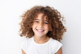 Close-up portrait of a smiling little girl with curly hair on a white background
