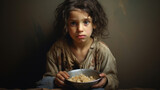 A somber young girl holding a bowl, evoking themes of poverty, hunger, and need.